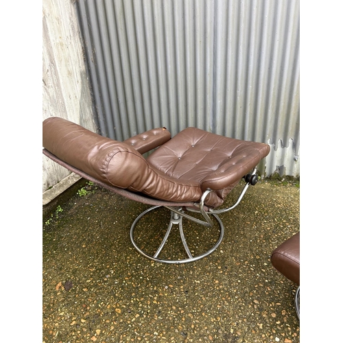 54 - A mid century chrome and brown leather reclining chair and stool