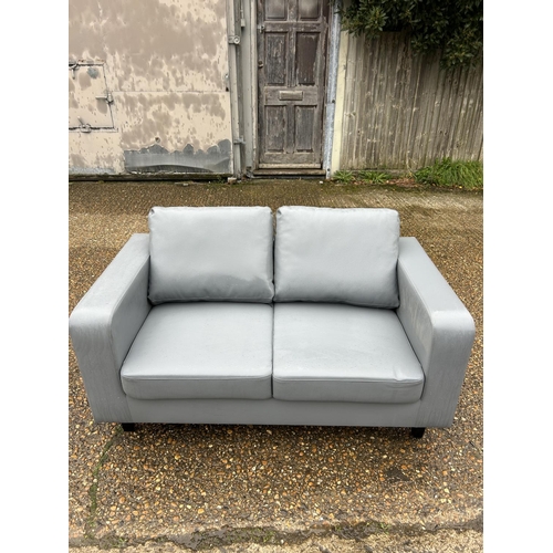 6 - As new ex shop display grey leather effect 2 seater sofa 138 cms wide