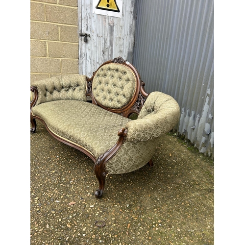 66 - A Victorian mahogany framed chaise lounge / love seat with green upholstery 170cm wide