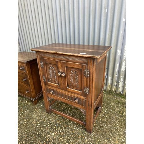 72 - Small linenfold oak cupboard together with matching chest of three drawers