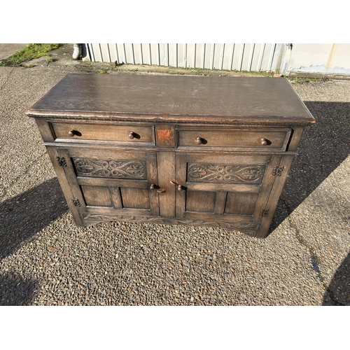 74 - A carved oak two drawer sideboard 138x50x90