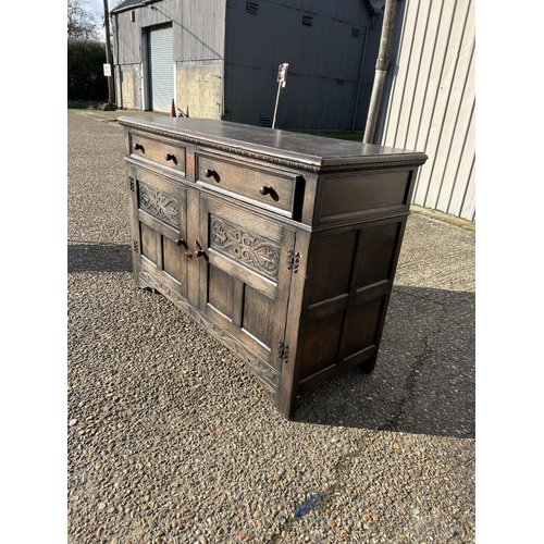 74 - A carved oak two drawer sideboard 138x50x90