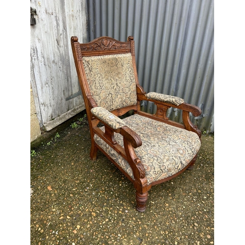 86 - An Edwardian oak framed chair together with a stick back carver chair