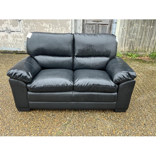 9 - As new ex shop display black leather effect two seater sofa, 160 wide