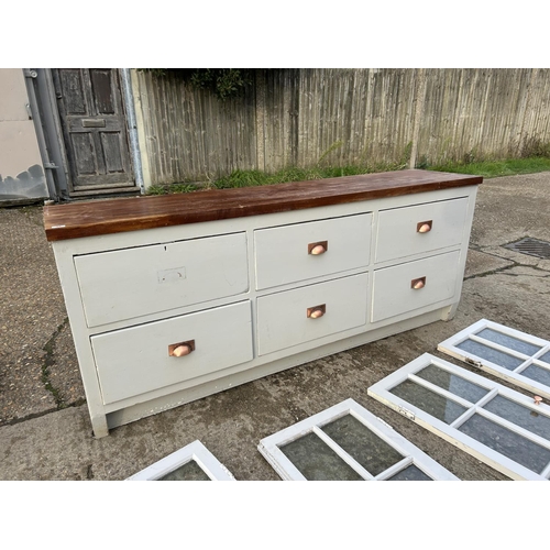 98 - A large antique painted pine six drawer dresser base, fitted with later worktop and painted, with gl... 