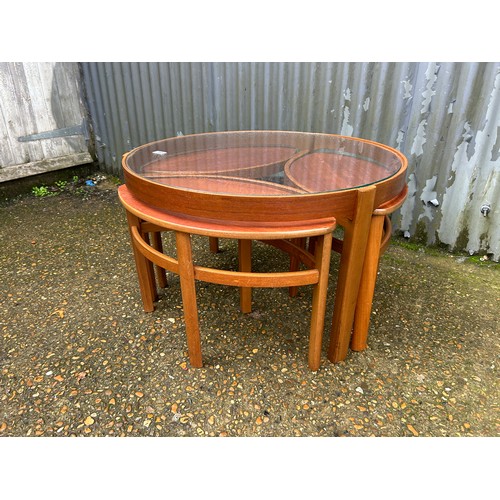 165 - A Nathan teak nest of tables with glass top