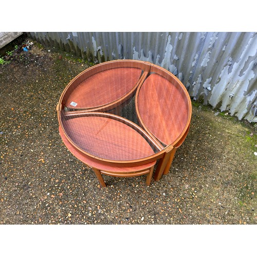 165 - A Nathan teak nest of tables with glass top