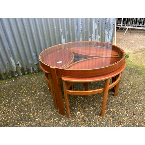 165 - A Nathan teak nest of tables with glass top