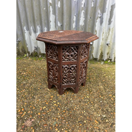 166 - An eastern style hardwood table with folding base