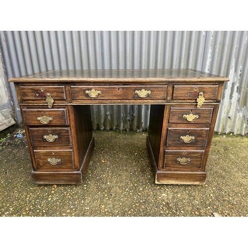 100D - An oak twin pedestal desk with green leather top