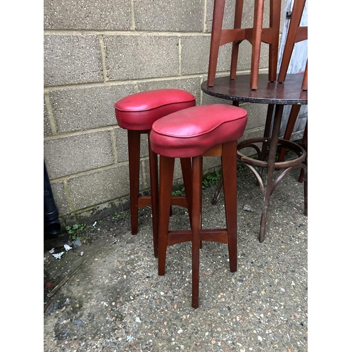 10 - A bentwood style circular cafe table together with six bar stools with red vinyl seats