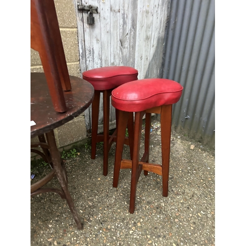 10 - A bentwood style circular cafe table together with six bar stools with red vinyl seats