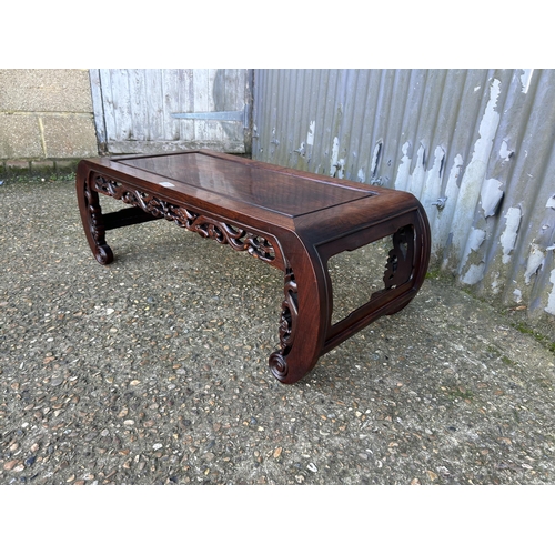 135 - An oriental hardwood coffee table 95x33x43