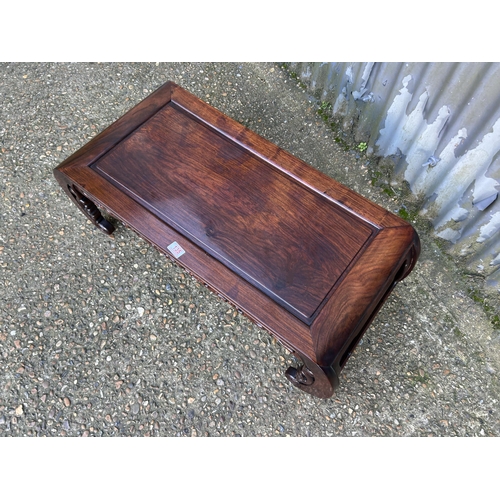 135 - An oriental hardwood coffee table 95x33x43