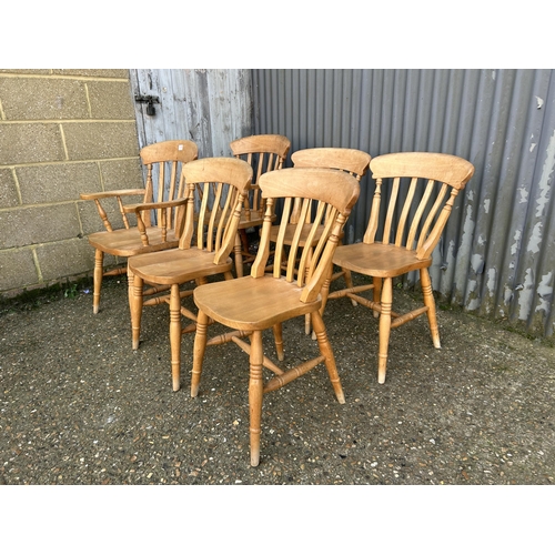 139 - A set of six pine dining chairs inc 2 carvers