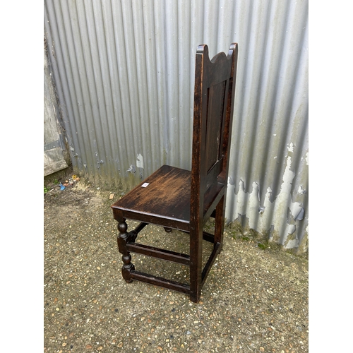 141 - A carved oak panel back chair