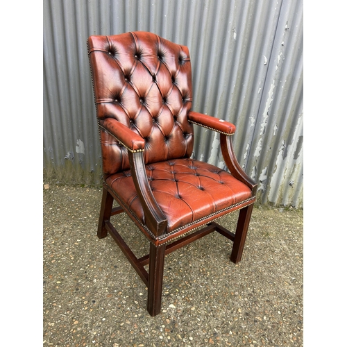 153 - A red leather chesterfield Gainsborough chair