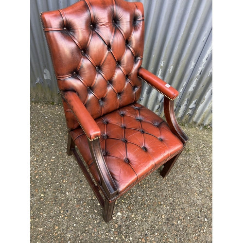 153 - A red leather chesterfield Gainsborough chair