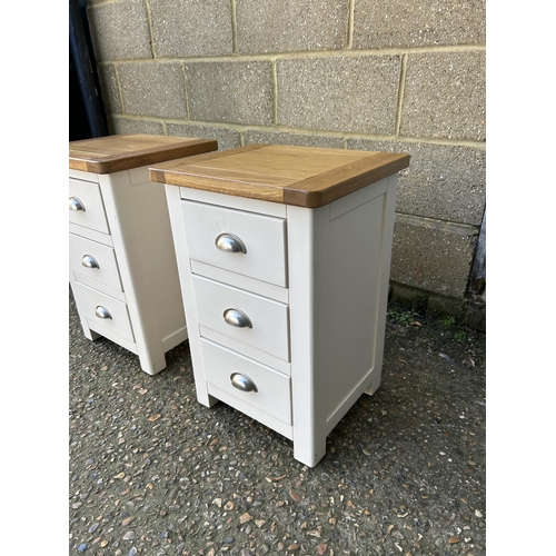 160 - A pair of painted light oak three drawer bedsides