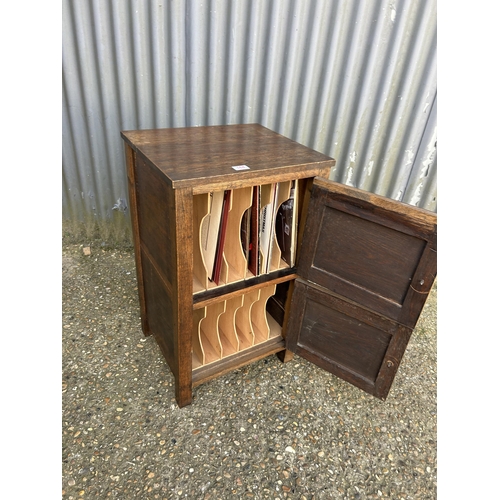 164 - An oak two door record cupboard