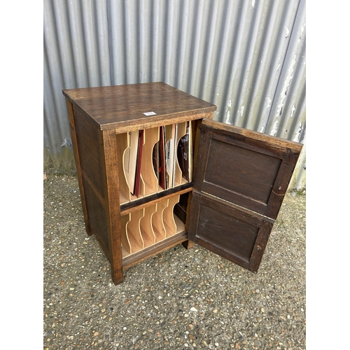 164 - An oak two door record cupboard