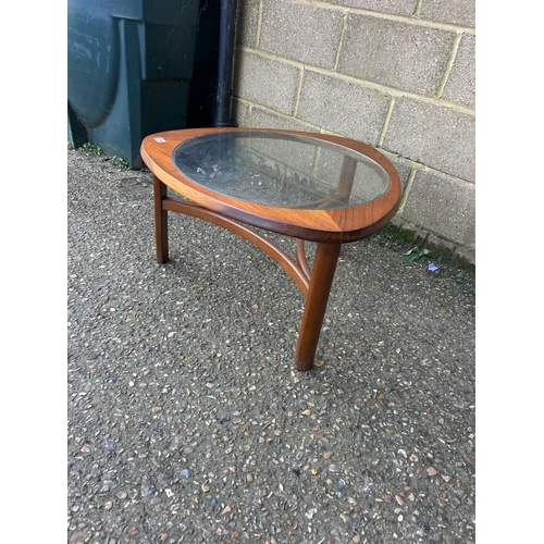 166 - A circular teak coffee table with drop in glass top