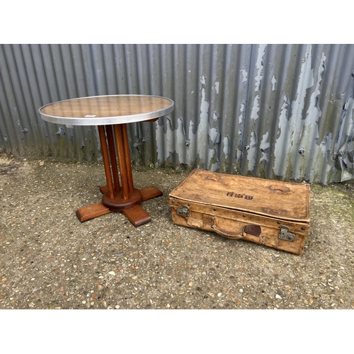 180 - A deco style circular occasional table, together vintage leather suitcase