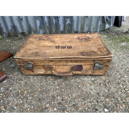 180 - A deco style circular occasional table, together vintage leather suitcase