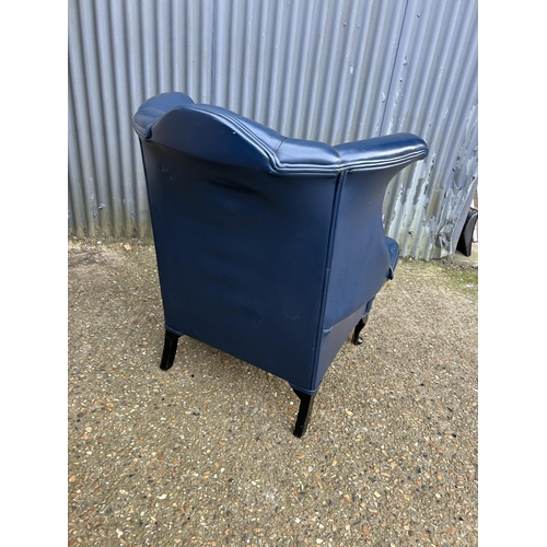 183 - A blue leather chesterfield wing back armchair