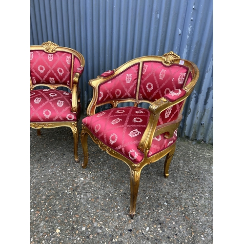 187 - A pair of gold gilt and red upholstered throne chairs