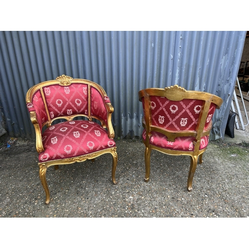 187 - A pair of gold gilt and red upholstered throne chairs