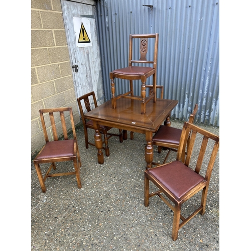 195 - A early 20th century oak drawer leaf table with six chairs