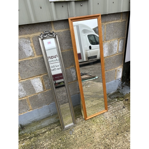 204 - A slim silver gilt mirror and another teak framed wall mirror