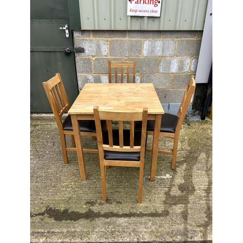 207 - A modern light oak table and four chairs 75cm square