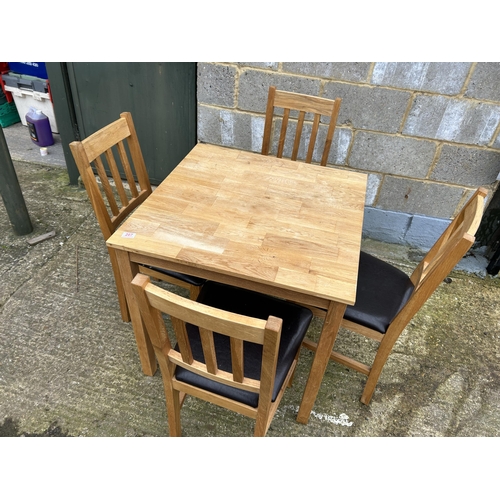 207 - A modern light oak table and four chairs 75cm square