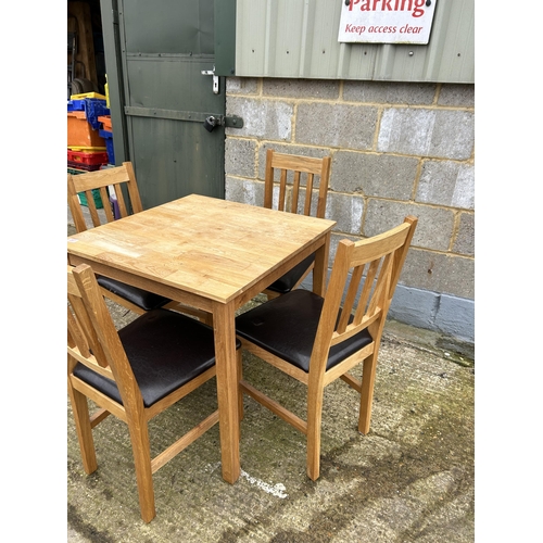 207 - A modern light oak table and four chairs 75cm square