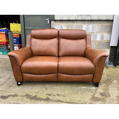 212 - A good quality soft brown leather two seater sofa by PARKER KNOLL approx one year old, still with la... 