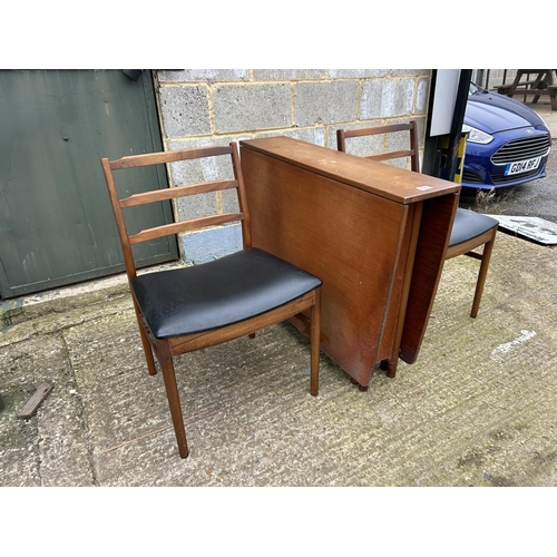 224 - A mid century  teak gate leg table and two chairs