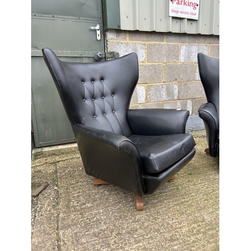 225 - A pair of g plan or similar mid century black vinyl swivel and recline armchairs (one af to cushion)