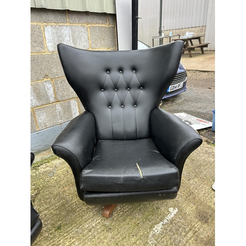 225 - A pair of g plan or similar mid century black vinyl swivel and recline armchairs (one af to cushion)