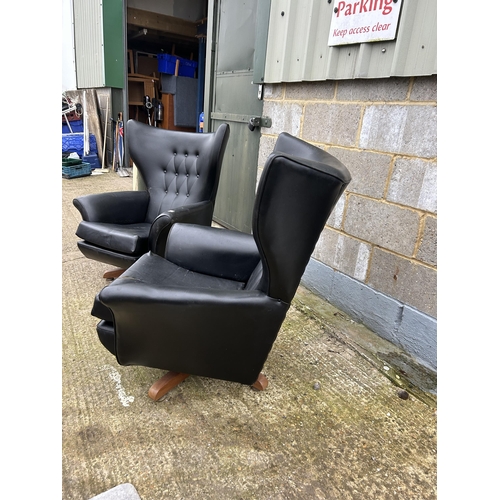 225 - A pair of g plan or similar mid century black vinyl swivel and recline armchairs (one af to cushion)