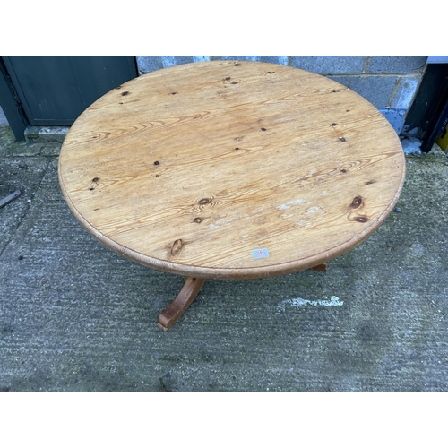 245 - A circular pine kitchen table 116cm diameter