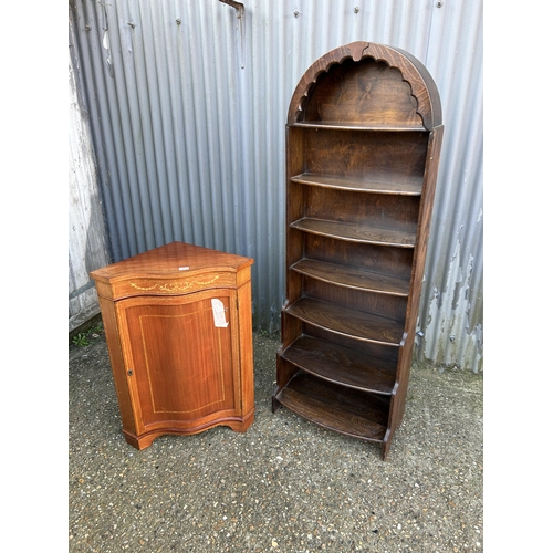 25 - An oak waterfall front bookcase together with a inlaid mahogany corner cupboard