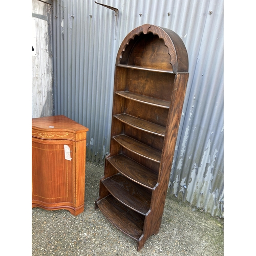 25 - An oak waterfall front bookcase together with a inlaid mahogany corner cupboard