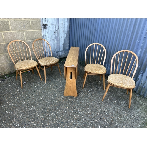 31 - A ercol light elm gate leg table with four stick back chairs