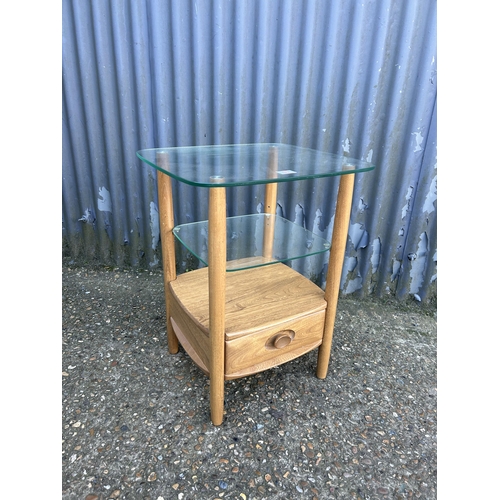 33 - A modern ercol light elm side table with glazed top and single drawer