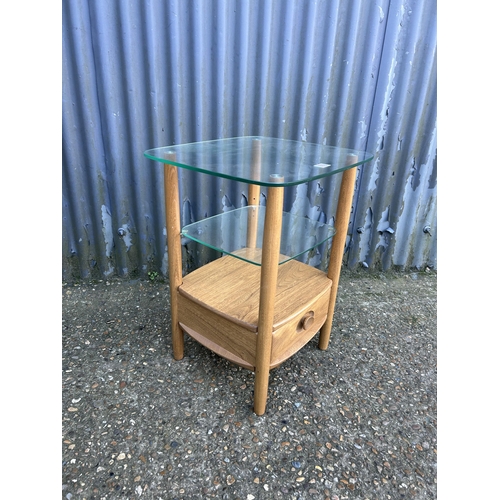 33 - A modern ercol light elm side table with glazed top and single drawer