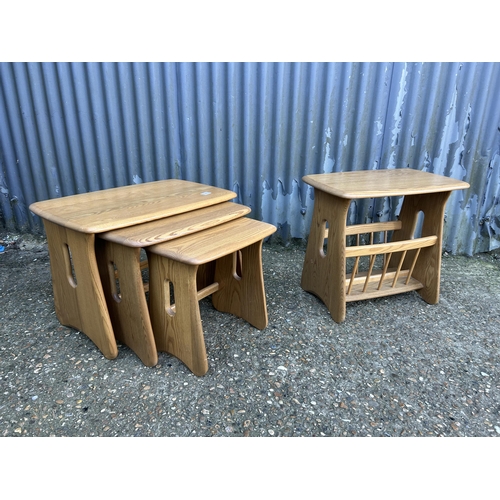 34 - A modern ercol light elm nest of three together with matching side table