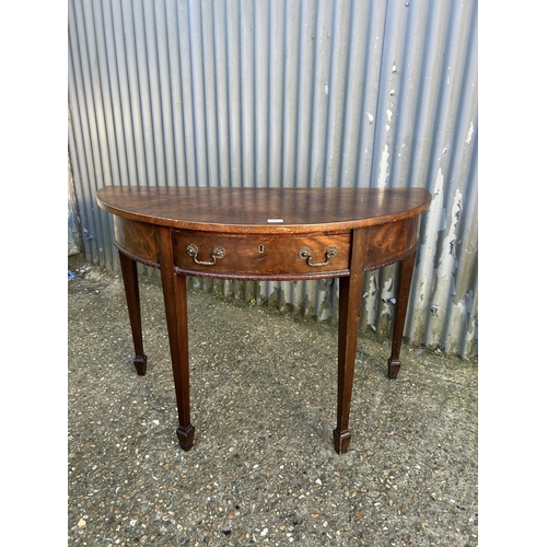 41 - A mahogany demi lune hall table 116cm wide