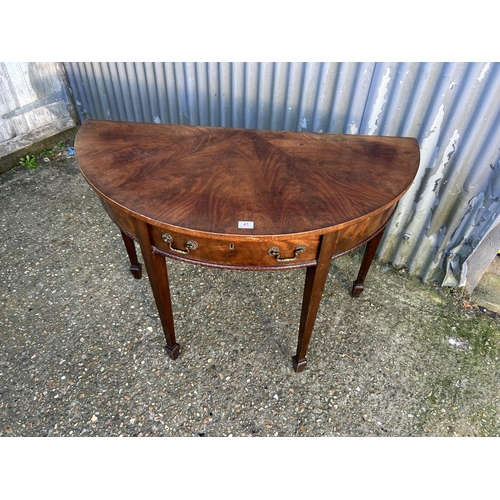 41 - A mahogany demi lune hall table 116cm wide